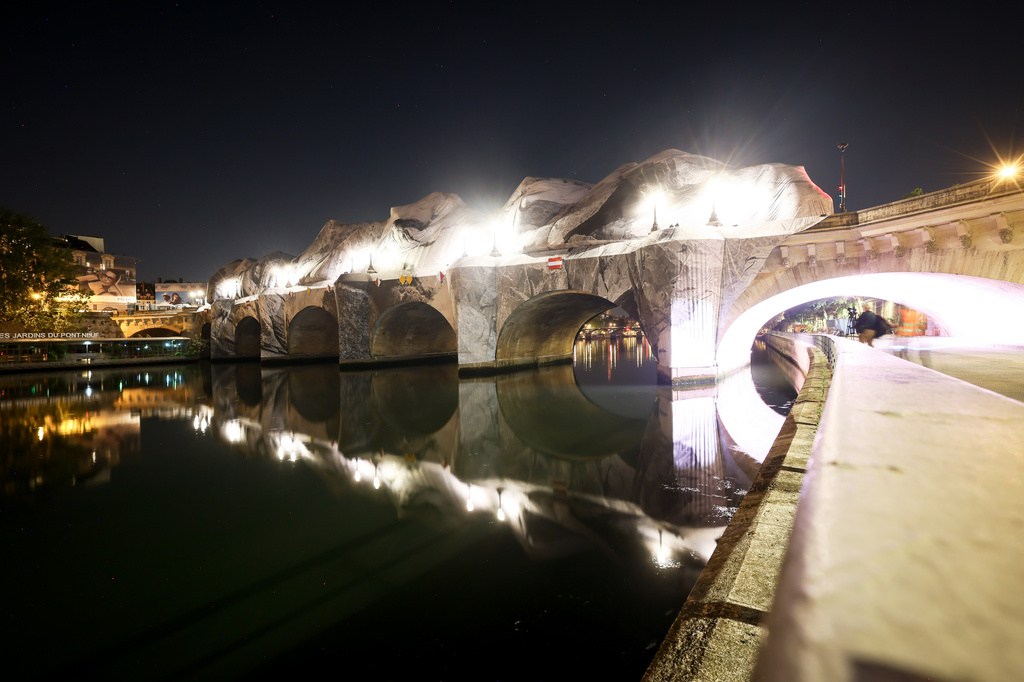 French artist JR begins his giant ‘cave’ art inflation over Paris’ oldest bridge