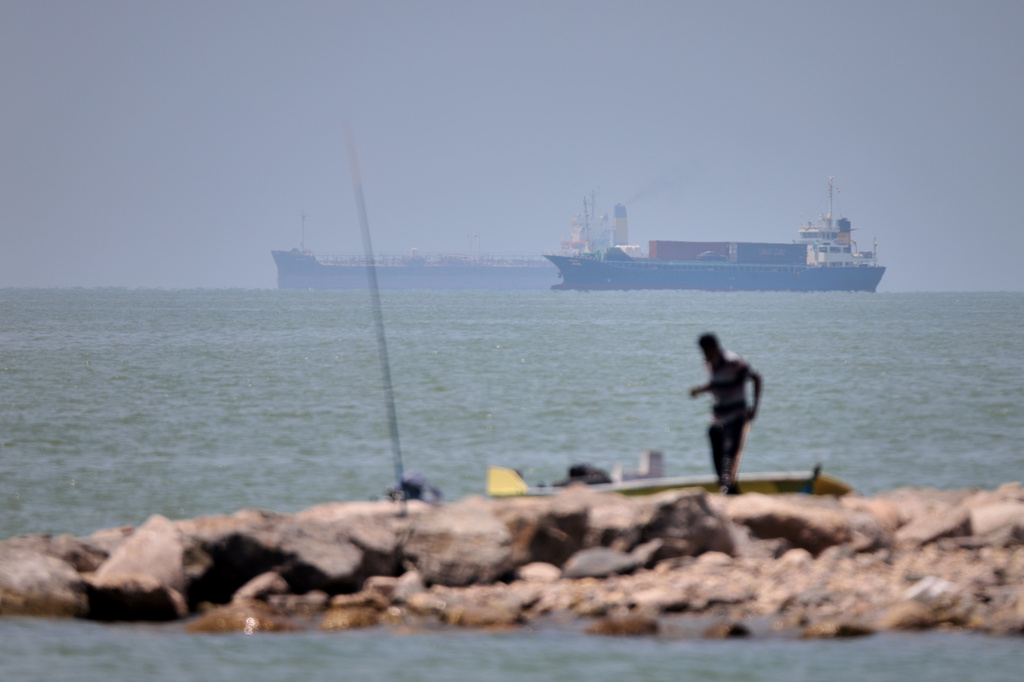 Iranian drones attack Bahrain and a ship is struck in the strait after US airstrikes