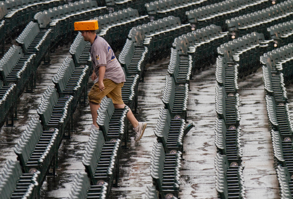 The cheesehead hat is a sunny nod to America’s ‘Hold my beer’ exuberance