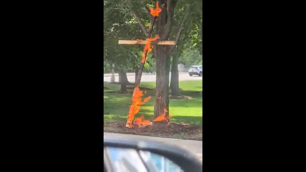 Police are investigating a large burning cross at a Chicago park