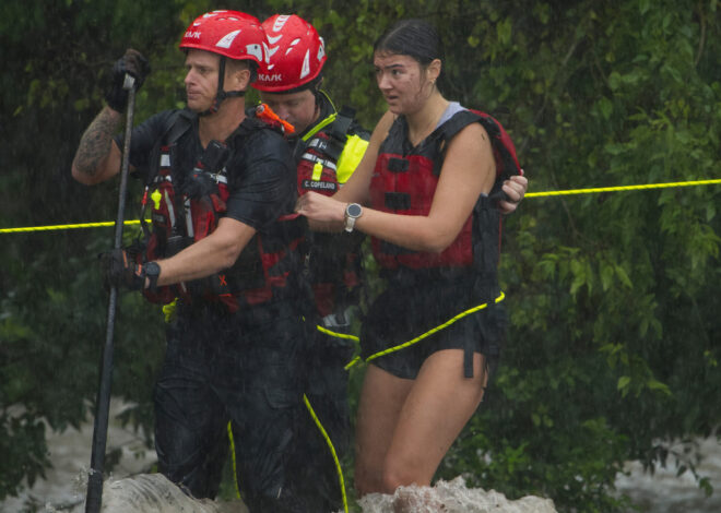Texas flooding surges from huge rainstorms as rescuers pull people from rising waters