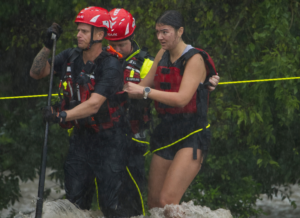 Texas flooding surges from huge rainstorms as rescuers pull people from rising waters