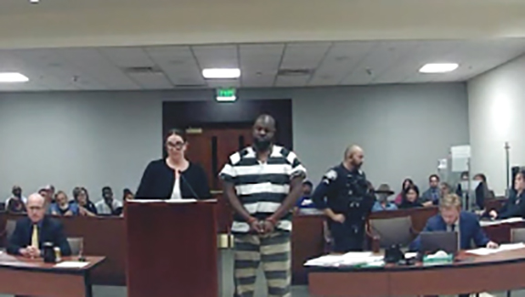 GEO Group employee accused of shooting protester has jail bond, charges reduced