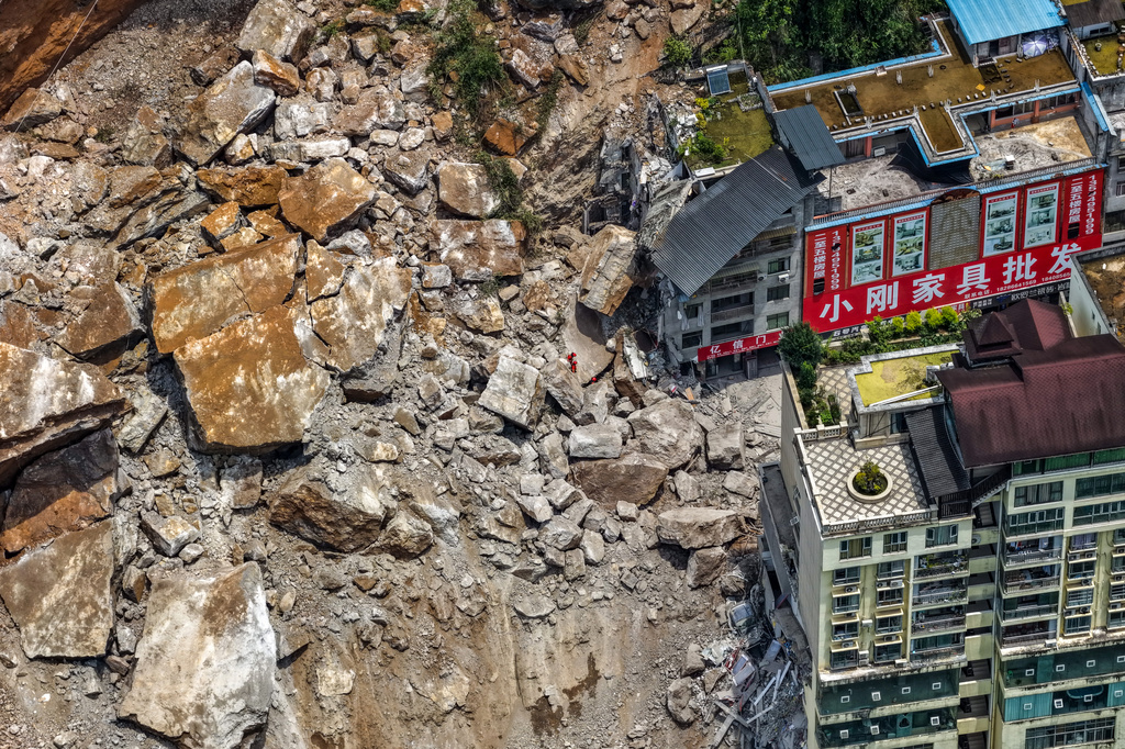 A landslide in southwest China buries homes and forces more than 1,000 to evacuate