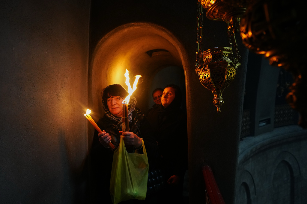 An AP reporter spends the night locked inside Jerusalem’s holiest church with clergy and pilgrims
