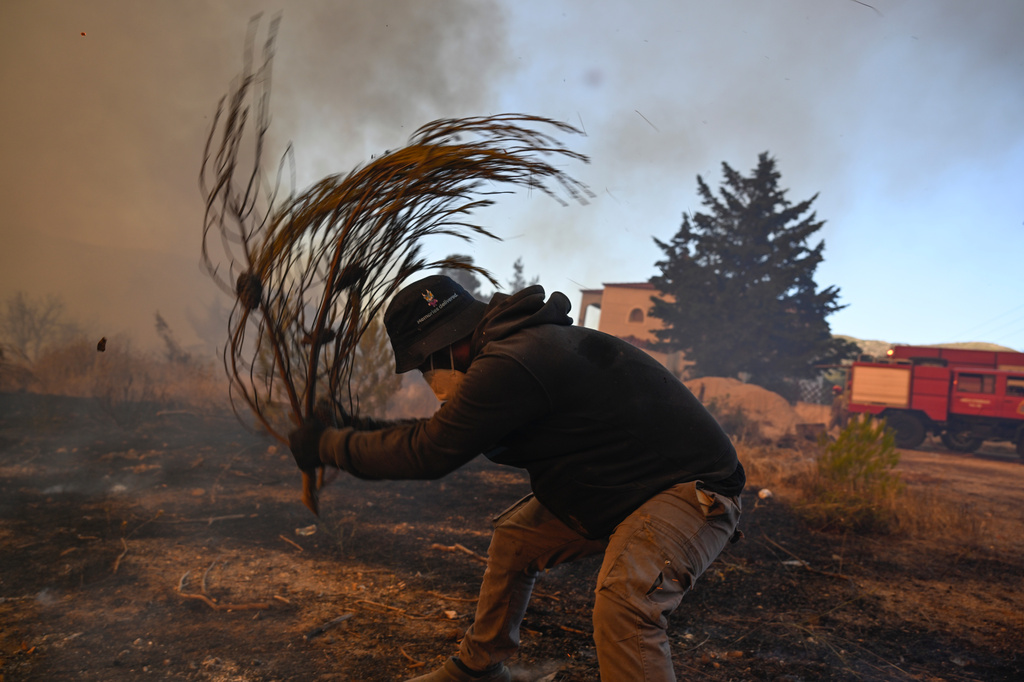 Water-dropping planes battle Athens wildfire as England records driest-ever July